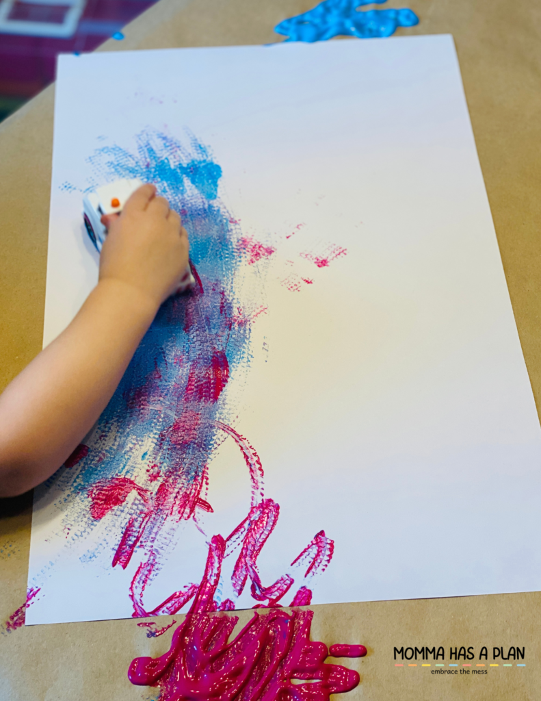 example of toddler painting with a toy car