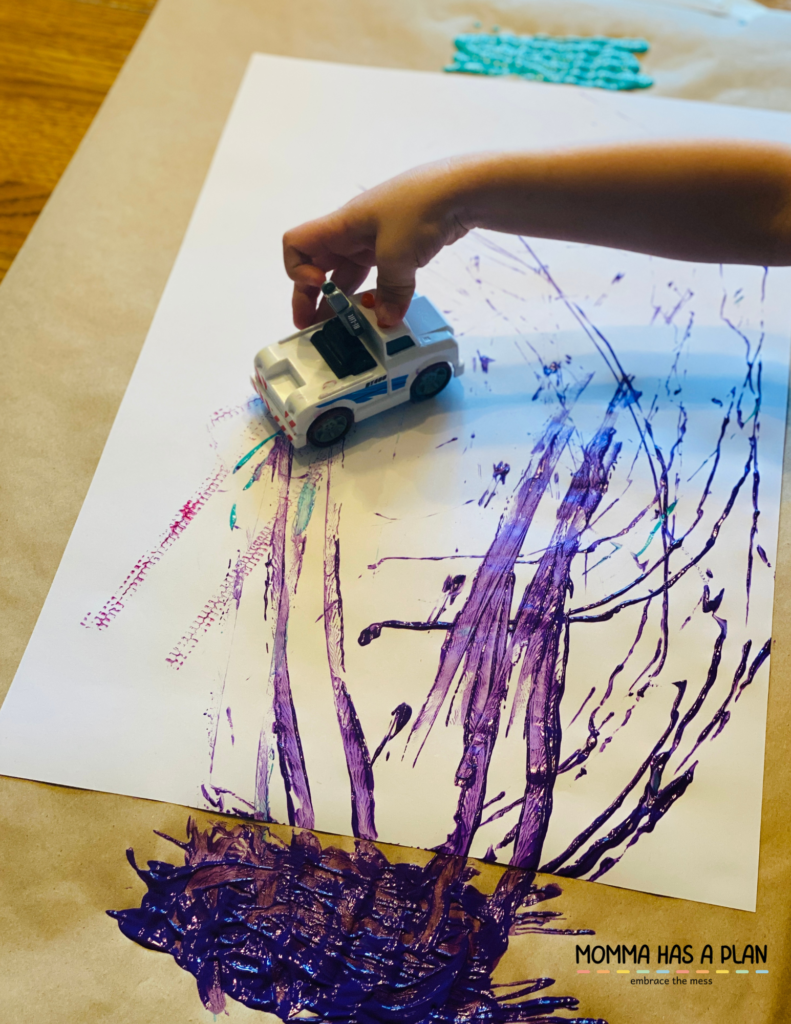 example of toddler painting with a toy car