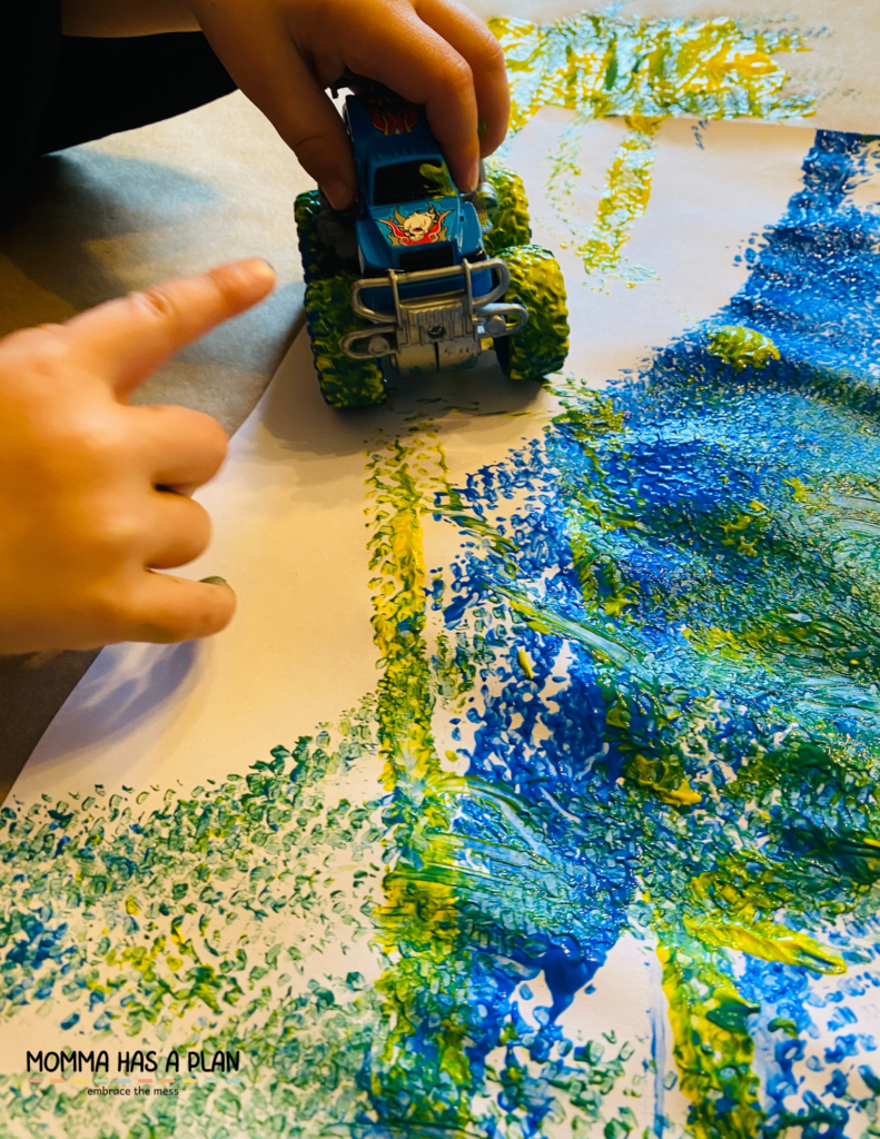 Toy car painting with mixing colors. Blue plus yellow makes green.